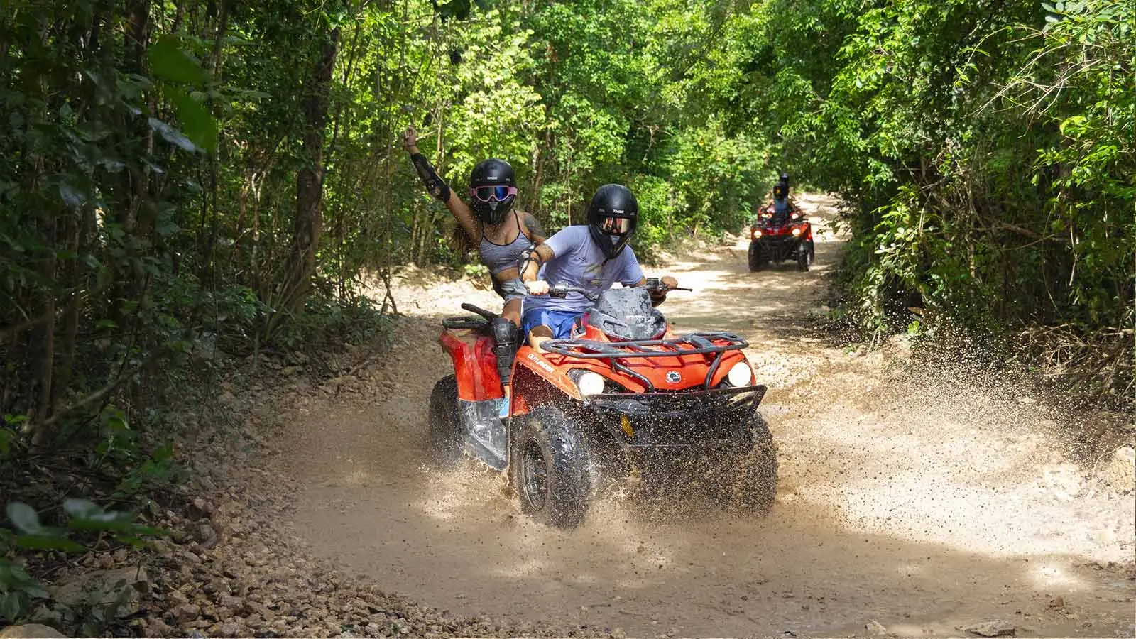 Turistas disfrutando de una expedición en cuatrimoto por los senderos selváticos de Tulum